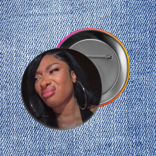 A close-up of a person's face with large hoop earrings, set against a denim fabric background.